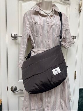 Dark brown puffer-style crossbody or messenger bag.